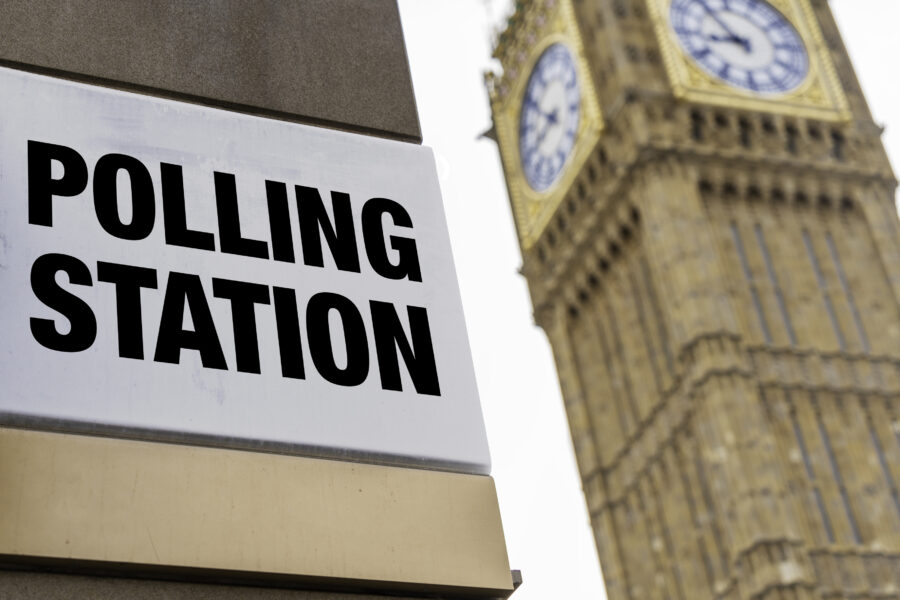 Closeup of polling station sign in front of Westminster